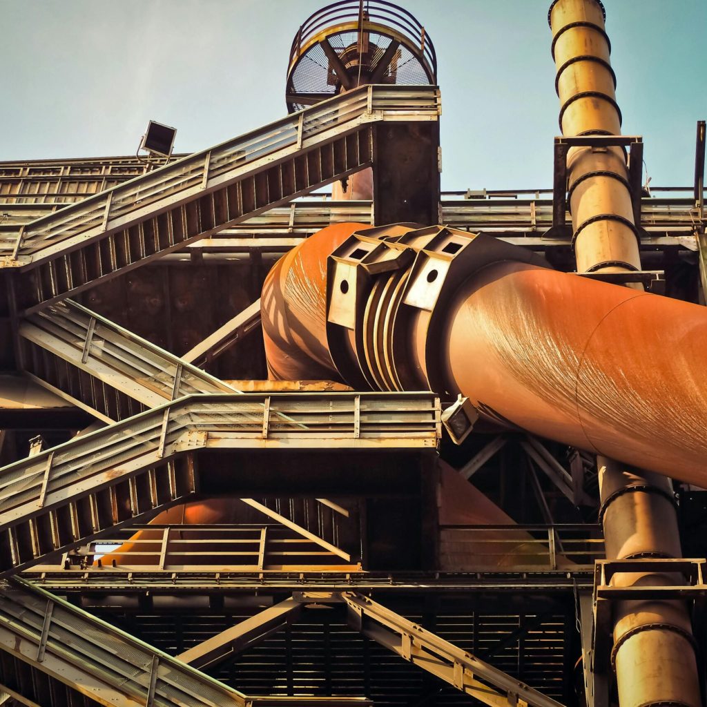 pexels photo 208661 208661 Close-up view of a rusty industrial structure with large pipes and steel framework, showcasing industrial decay.